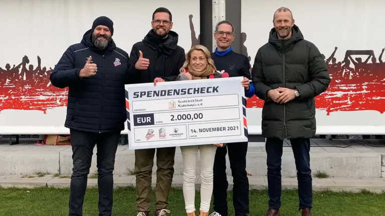 5 Personen halten großen Spendengutschein vor sich